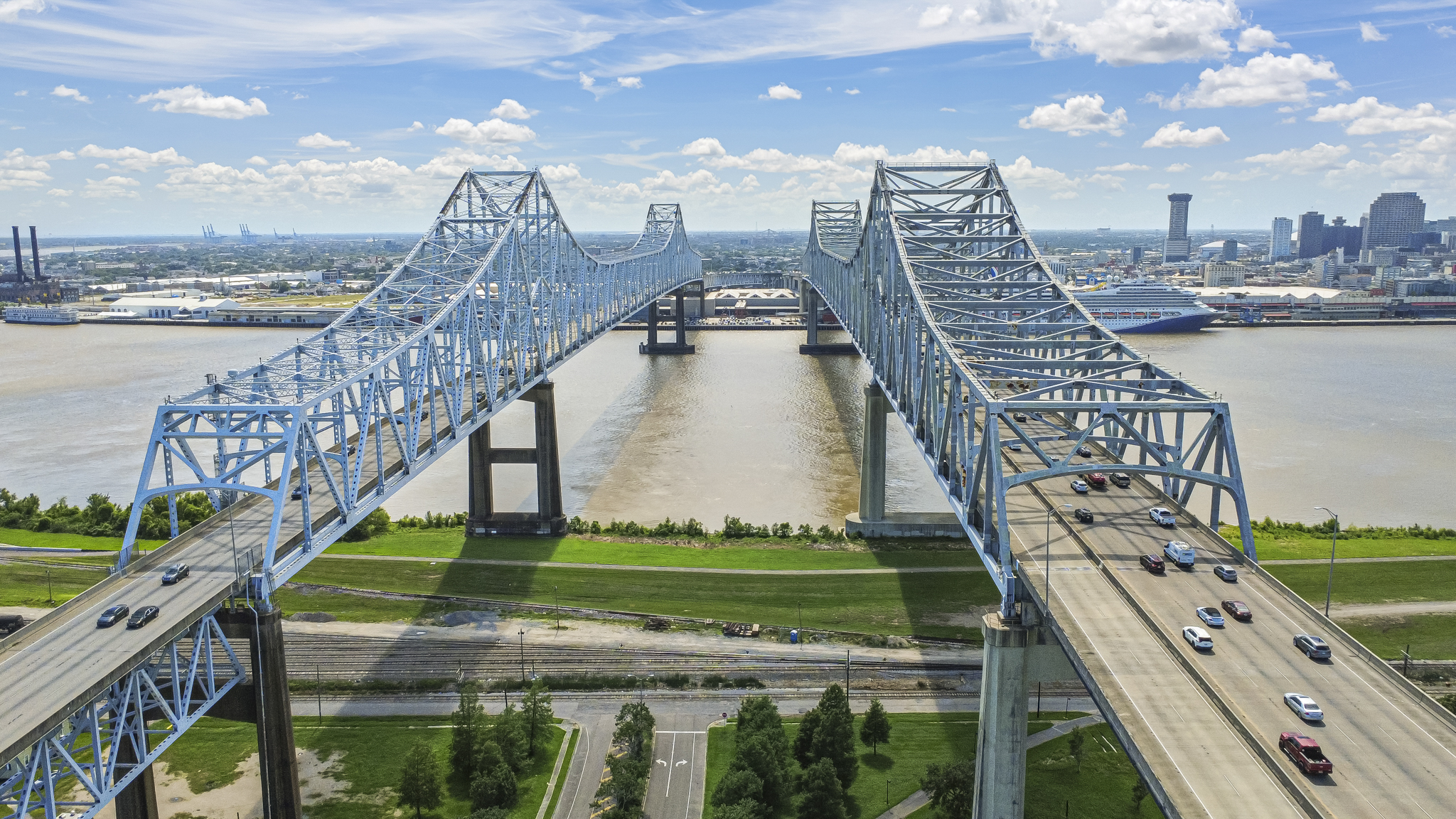Aerial view of the Crescent City Connection bridge over the Mississippi River with the New Orleans skyline