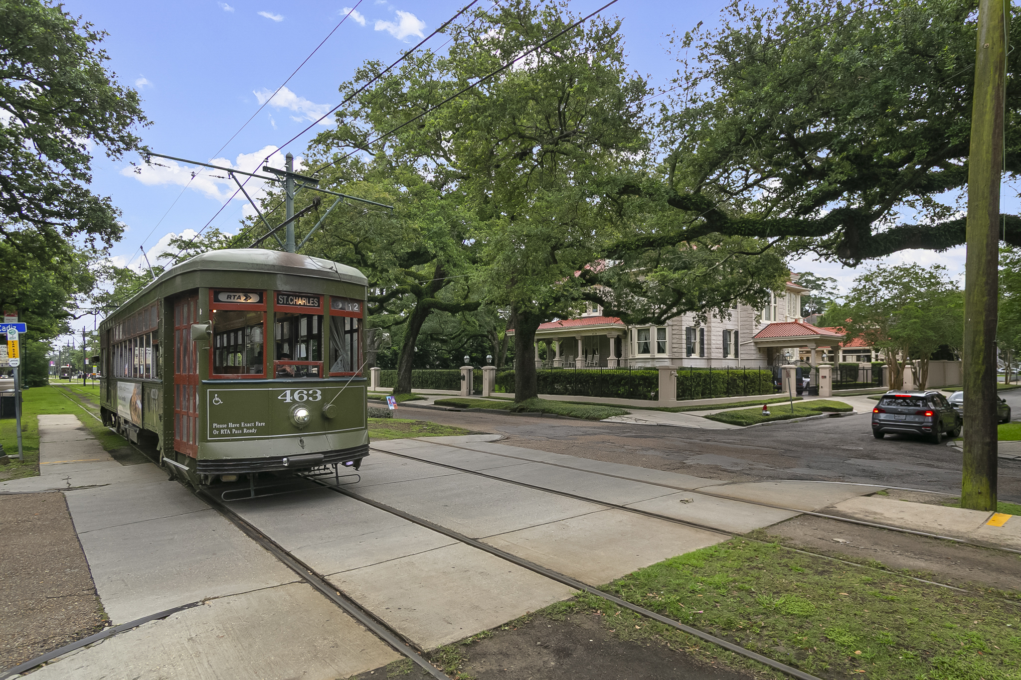 The St. Charles Avenue streetcar passing oak-shaded Uptown New Orleans mansions